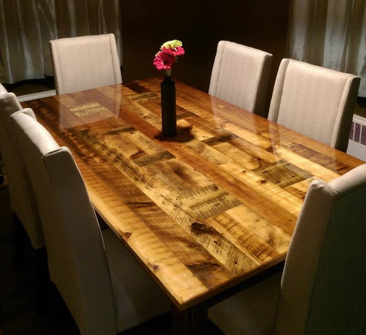A wooden epoxy table top in a dining room, surrounded by chairs.
