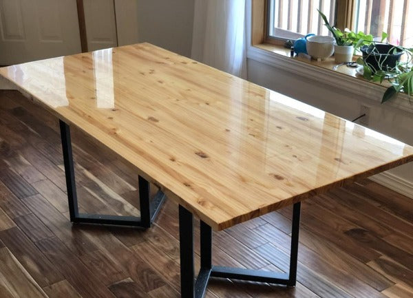 A wooden table top with a clear epoxy resin finish.