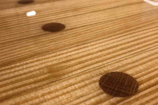 A close-up view of a wooden epoxy table top finish