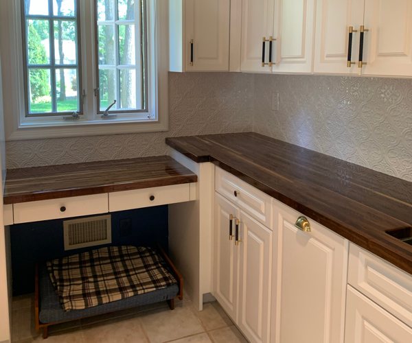 An epoxy resin kitchen countertop with dark wood.