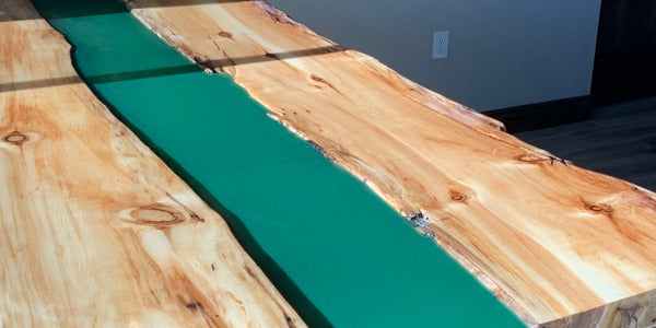 An epoxy river table colored with epoxy liquid dyes.