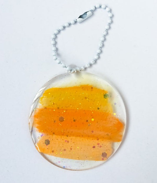 An epoxy keychain with a white-colored chain.
