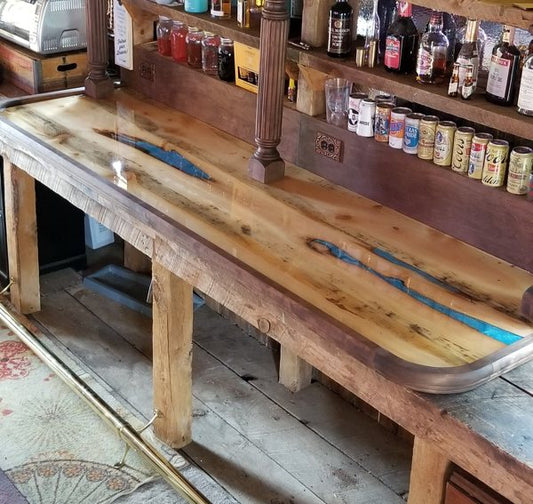 An outdoor wooden epoxy bar top with a perfectly poured coating of epoxy resin.
