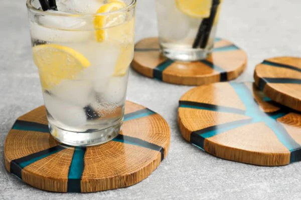Several epoxy coasters, made using wood and epoxy with a turquoise tint.