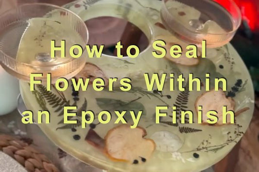 An epoxy resin tray with cup holder slots and flowers embedded within the finish.