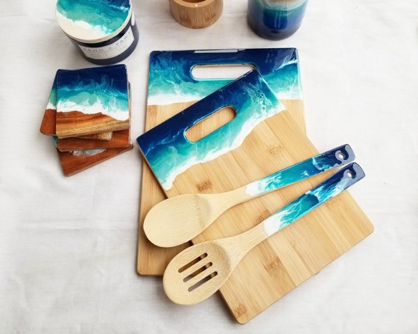 A set of epoxy resin kitchen accessories made with wood and colorful pigments.