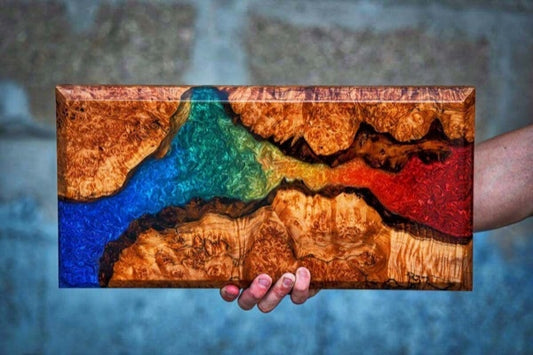An epoxy resin board with an epoxy vein colored by several mica powder pigments of blue, green, yellow, and red.