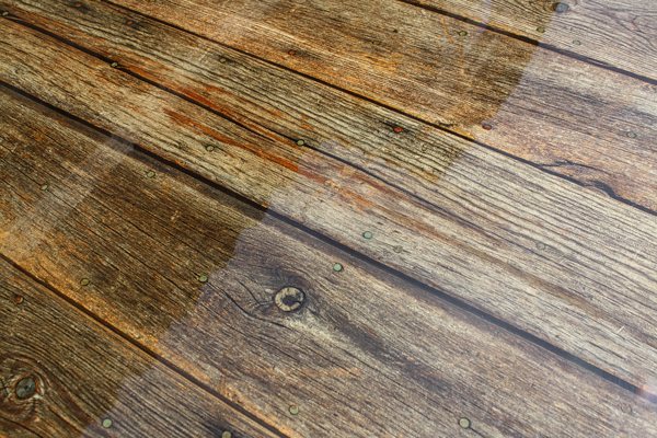 A wooden epoxy table top surface with a perfectly applied seal and flood coat, resulting in exceptional air bubble prevention.