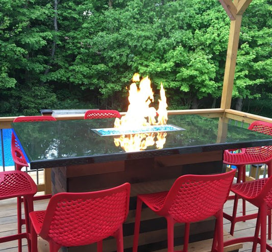 An outdoor epoxy bar top with a built-in fire pit and a wooden shelter to protect it from direct sunlight and other weather elements.
